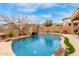 Serene pool area complete with rock waterfall, desert landscaping, and privacy fencing for tranquil outdoor living at 16830 S Coleman St, Phoenix, AZ 85045