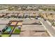 An aerial view shows a neighborhood with neat houses, streets, and a distant road at 17055 W El Caminito Dr, Waddell, AZ 85355