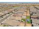 Expansive aerial view of a community with homes, green spaces, and a pool visible at 17055 W El Caminito Dr, Waddell, AZ 85355