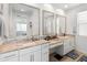 Bright bathroom featuring a granite countertop, vanity, and dual mirrors at 17055 W El Caminito Dr, Waddell, AZ 85355