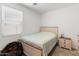 Comfortable bedroom featuring a window, neutral tones, and natural light at 17055 W El Caminito Dr, Waddell, AZ 85355