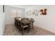 Dining room features a large table with seating for ten and various wall art decorations at 17055 W El Caminito Dr, Waddell, AZ 85355