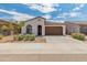 A well-kept single-Gathering home with a two-car garage and tidy front yard landscaping at 17055 W El Caminito Dr, Waddell, AZ 85355