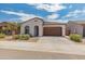 Beautiful single-Gathering home featuring a two-car garage and manicured landscaping at 17055 W El Caminito Dr, Waddell, AZ 85355