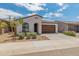 Charming single-story home featuring a well-maintained front yard and a two-car garage at 17055 W El Caminito Dr, Waddell, AZ 85355