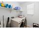 Clean laundry room with front load washer and dryer and shelving for storage solutions at 17055 W El Caminito Dr, Waddell, AZ 85355