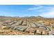 Expansive aerial view of a vibrant neighborhood nestled near mountains, showcasing a well-planned community at 1743 W Flintlock Dr, San Tan Valley, AZ 85144