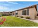 Backyard with green grass, garden bed and house exterior at 1743 W Flintlock Dr, San Tan Valley, AZ 85144