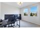 Bright bedroom with large windows, neutral carpet, stylish light fixture, and a dark desk at 1743 W Flintlock Dr, San Tan Valley, AZ 85144