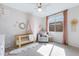 Cozy Bedroom with a wooden crib, glider chair, pink accents, and natural light from a window at 1743 W Flintlock Dr, San Tan Valley, AZ 85144