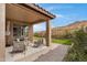 Relaxing covered patio area with comfortable seating and view of landscaped backyard at 1743 W Flintlock Dr, San Tan Valley, AZ 85144