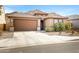 Inviting single-story home featuring a tile roof, a two-car garage, and desert-friendly landscaping at 1743 W Flintlock Dr, San Tan Valley, AZ 85144