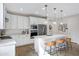 Bright kitchen featuring white cabinets, stainless steel appliances, and a kitchen island with seating at 1743 W Flintlock Dr, San Tan Valley, AZ 85144