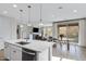 Open concept kitchen with white cabinets and a view of the living and dining areas at 1743 W Flintlock Dr, San Tan Valley, AZ 85144