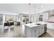 Open concept kitchen with white cabinetry, stainless steel appliances and an island at 1743 W Flintlock Dr, San Tan Valley, AZ 85144