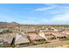 Serene neighborhood view featuring well-maintained homes, manicured landscaping, and scenic mountain vistas in the distance at 1743 W Flintlock Dr, San Tan Valley, AZ 85144