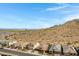 Beautiful view of a desert neighborhood nestled against a scenic mountain backdrop under a bright, blue sky at 1743 W Flintlock Dr, San Tan Valley, AZ 85144