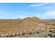 Expansive aerial view of a desert neighborhood situated near scenic mountains, blending community and nature at 1743 W Flintlock Dr, San Tan Valley, AZ 85144