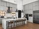 A modern gray kitchen features a large island with seating and stainless steel appliances at 17723 W Amber Dr, Goodyear, AZ 85338