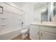 Clean, well-lit bathroom featuring a shower-tub combo, tile floors, and vanity at 18432 W Mohave St, Goodyear, AZ 85338