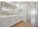 Elegant bathroom featuring a double vanity, large mirror, and a tiled shower, creating a spa-like experience at 18432 W Mohave St, Goodyear, AZ 85338