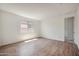 Spacious bedroom featuring wood floors and a large window at 18432 W Mohave St, Goodyear, AZ 85338