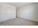 Cozy bedroom with plush carpeting, a large closet, and ample natural light at 18432 W Mohave St, Goodyear, AZ 85338