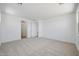 Spacious bedroom featuring neutral carpet, bright windows, and multiple doorways to additional rooms at 18432 W Mohave St, Goodyear, AZ 85338