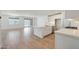 Open floor plan showcasing the modern kitchen with a center island, stainless appliances, and adjacent living area at 18432 W Mohave St, Goodyear, AZ 85338