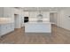 Bright kitchen featuring white cabinets, a center island, stainless steel appliances, and stylish backsplash at 18432 W Mohave St, Goodyear, AZ 85338