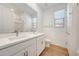 Well-lit bathroom with double sinks and wood-look tile flooring at 18444 W Mohave St, Goodyear, AZ 85338