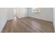 Bright bedroom features a window and wood-look tile flooring at 18444 W Mohave St, Goodyear, AZ 85338