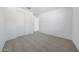 Bedroom featuring carpeted floors and a closet with white doors at 18444 W Mohave St, Goodyear, AZ 85338
