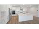 Well-equipped kitchen features white cabinets, stainless steel appliances, and a large center island at 18444 W Mohave St, Goodyear, AZ 85338