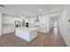 Spacious kitchen with white cabinetry, a center island, stainless steel appliances and subway tile backsplash at 18444 W Mohave St, Goodyear, AZ 85338