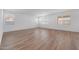 Bright living area with wood-look flooring, offering a versatile space with natural light and neutral tones at 18444 W Mohave St, Goodyear, AZ 85338