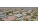 Wide aerial shot of houses in a residential neighborhood highlighting a well-maintained home with a backyard pool at 19318 E Walnut Rd, Queen Creek, AZ 85142