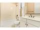 Bright bathroom with a shower-tub combo and a vanity with bronze hardware and faucet at 19318 E Walnut Rd, Queen Creek, AZ 85142