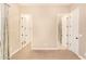 Neutral bedroom with doorways to the bathroom and walk-in closet at 19318 E Walnut Rd, Queen Creek, AZ 85142