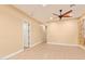 Bedroom with wood-look tile flooring, ceiling fan, and neutral paint at 19318 E Walnut Rd, Queen Creek, AZ 85142