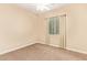 Carpeted bedroom with a ceiling fan, window, and neutral-colored walls at 19318 E Walnut Rd, Queen Creek, AZ 85142