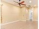 Spacious bedroom features wood-look tile flooring, ceiling fan and ensuite bathroom at 19318 E Walnut Rd, Queen Creek, AZ 85142