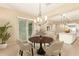 Elegant dining room with a modern chandelier, adjacent kitchen, and a cozy atmosphere at 19318 E Walnut Rd, Queen Creek, AZ 85142