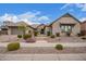 Beautiful single-story home featuring a stone facade, tile roof, and professionally landscaped front yard at 19318 E Walnut Rd, Queen Creek, AZ 85142