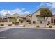 Charming home featuring a three-car garage, stone accents, tiled roof, and easy to maintain front yard at 19318 E Walnut Rd, Queen Creek, AZ 85142