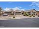 Charming home featuring a three-car garage, stone accents, tiled roof, and easy to maintain front yard at 19318 E Walnut Rd, Queen Creek, AZ 85142