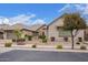 Charming home featuring a three-car garage, stone accents, tiled roof, and easy to maintain front yard at 19318 E Walnut Rd, Queen Creek, AZ 85142