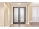 Elegant foyer features a custom iron entry door, herringbone floors, chandelier, and views into other rooms at 19318 E Walnut Rd, Queen Creek, AZ 85142