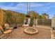 Cozy backyard with a fire pit, seating, desert landscaping, and perimeter foliage, ideal for outdoor relaxation and entertaining at 1975 E Sunburst Ln, Tempe, AZ 85284