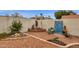 Charming backyard with desert landscaping, a cozy seating area, and unique decorative elements, creating a relaxing outdoor retreat at 1975 E Sunburst Ln, Tempe, AZ 85284